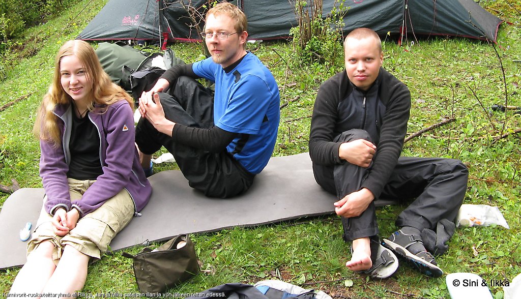 Karnivorit-ruoka/telttaryhmä eli Riikka, Jani ja Mika sateisen illan ja yön jälkeen teltan edessä.
